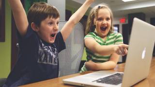 children celebrating on their computer