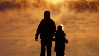 father and child in the fog