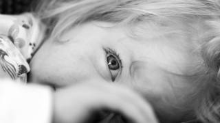 young girl looking through her hand