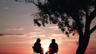 older people sitting watching the sunset