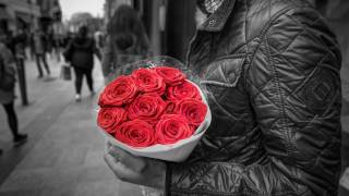 man holding red roses