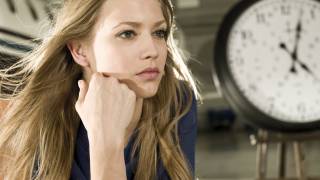 lady looking at a clock waiting for the plane