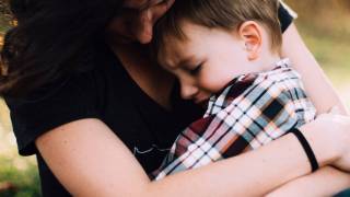 mom holding sick son