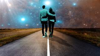 couple walking along a road in the starry night