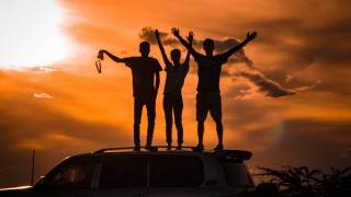 men celebrating on top of ridge