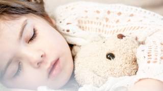 young sleeping little girl with Teddy bear