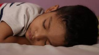 sleeping boy in bed