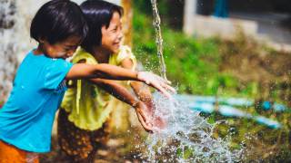 children playing in the water fountain