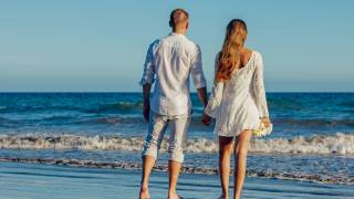 young couple looking at the surf