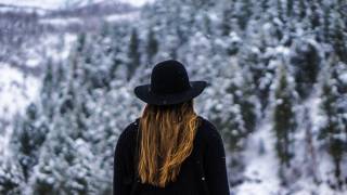 young women sitting in a snowy forest