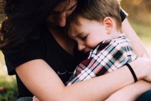 mom holding sick son